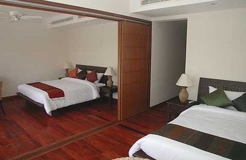 The guest bedrooms, with dividing partition drawn back
